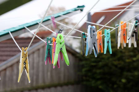 Close up of a colored clothespins on a clothesline.