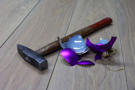 Broken Christmas tree toy next to the hammer.の写真素材