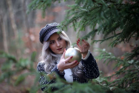 Portrait of a young girl by the christmas tree.の写真素材