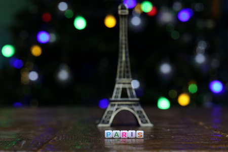 Plastic cubes with the word PARIS with the eiffel tower in the background.の写真素材