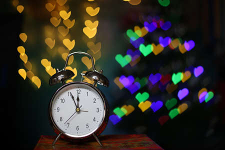 New year composition with alarm clock and beautiful bokeh in the background.の写真素材