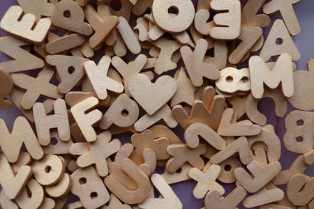 Letters, numbers and other figures sawn out of plywood.