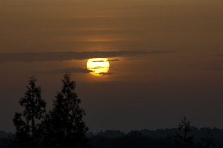 Beautiful sunset. Setting sun in the clouds.の写真素材