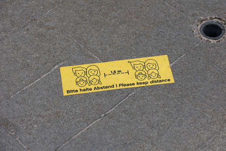Please keep distance - Information sign on the sidewalk during coronavirus time.の写真素材