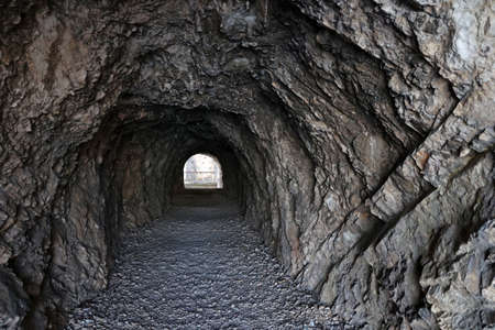 Small tunnel carved into the rock in the mountains.の写真素材