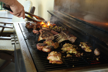 Fried meat on a gas grill, close-up.の写真素材