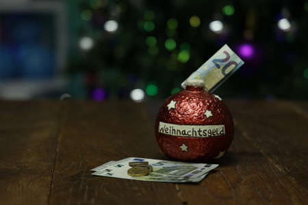 Christmas money in a piggy bank in the form of a Christmas tree toyの写真素材