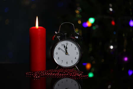 Christmas decoration with burning candles and alarm clockの写真素材