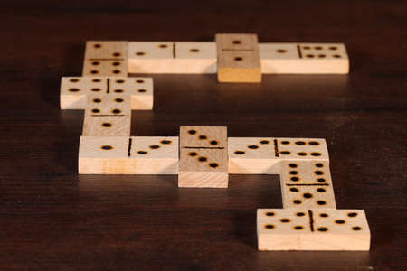 domino pieces on the brown wooden table backgroundの写真素材