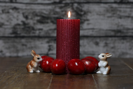 Festive composition with Easter eggs and candles.の写真素材