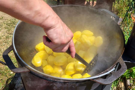 New potatoes are cooked in a cauldronの写真素材