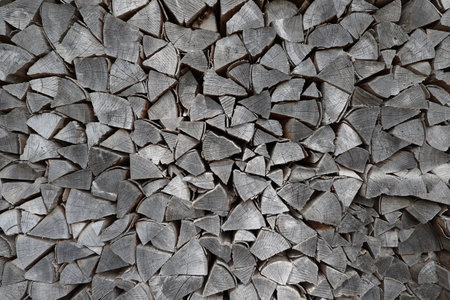 Dry firewood is evenly stacked in the woodpile.の写真素材