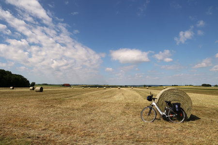 Landscape with harvested fields and rolls of hay.の写真素材