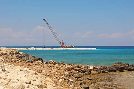 Construction work is underway on the coast of the seaの写真素材