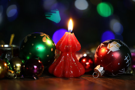 Burning decorative candle on christmas backgroundの写真素材