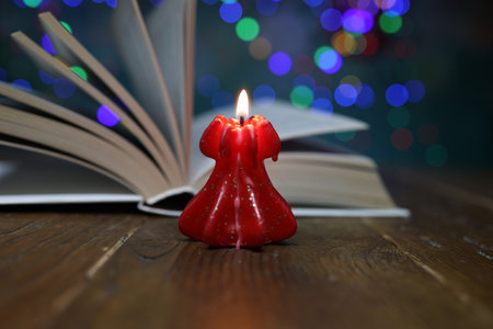 New Years motive. Burning candle on a blurred backgroundの写真素材