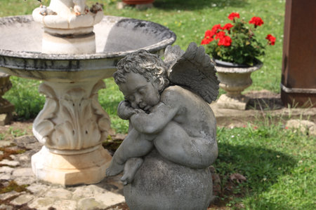 Sleeping angel figurine in the gardenの写真素材