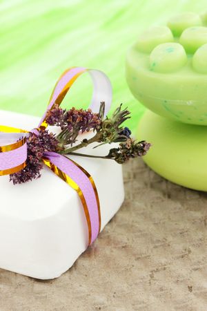 Soap and dry flowers against the light-green backgroundの写真素材