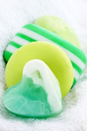 The pile of green soap on the white towelの写真素材