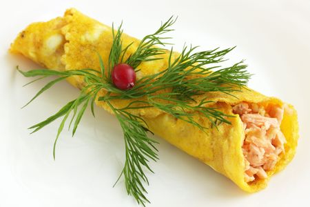 Fish covered into the pancake on the plateの写真素材