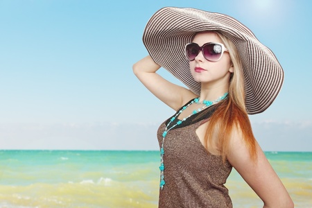 Beautiful woman in the hat near the seaの写真素材