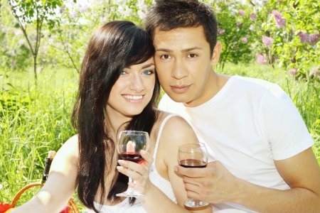 Young couple on a picnic, drink wineの写真素材