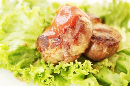 A juicy steak with lettuce and tomato sauceの写真素材