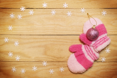 mittens, ball and snowflakes on a wooden boardの写真素材