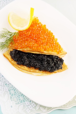 thin pancakes with red and black caviarの写真素材