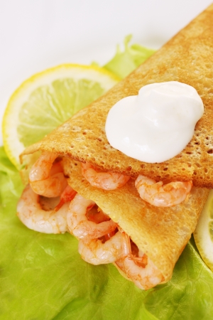 Ruddy thin pancake stuffed with shrimp and sour creamの写真素材