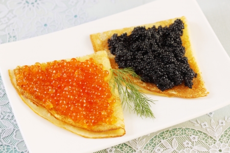 thin pancakes with red and black caviarの写真素材