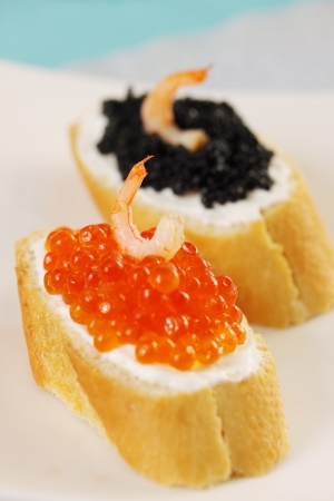 sandwich with red, black caviar and shrimpの写真素材