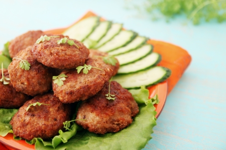 Fried cutlets with cucumber and watercress salad