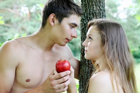 Adam and Eve with a red appleの写真素材