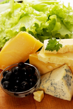 Still life of different types of cheese with olivesの写真素材