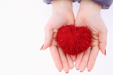  woman holding red Wool heart in handの写真素材