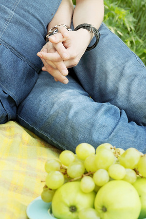 young couple holding hands on a picnicの写真素材