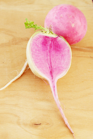 cut large purple radish on wooden boardの写真素材