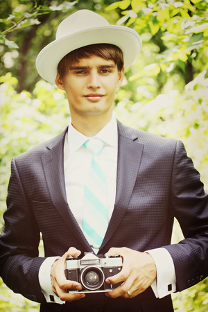The groom in a suit , photographs vintage cameraの写真素材