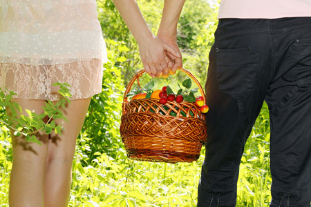 Young couple together bear fruit basket, close-upの写真素材