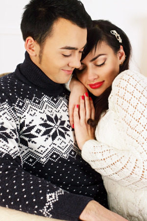 portrait of a beautiful young couple on a background of fireの写真素材