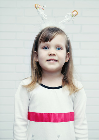 beautiful, blue-eyed girl in a celebratory Headbandの写真素材