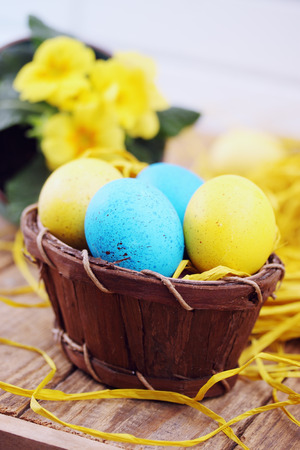 Easter still life in shades of yellow, nest with eggsの写真素材