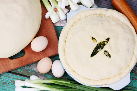 Homemade pie with onion, spinach and eggsの写真素材