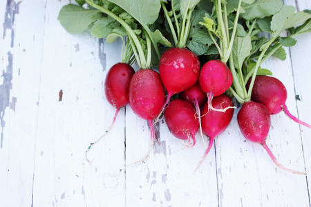 bunch of radishes on wooden boardsの写真素材