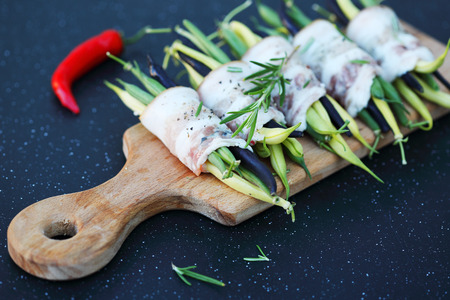 green beans wrapped in bacon with spicesの写真素材