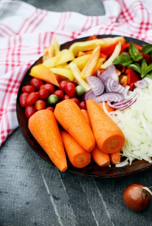 Sliced summer vegetables prepared for salad, food is a top viewの写真素材
