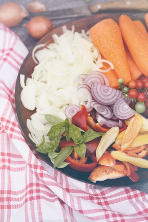 Sliced summer vegetables prepared for salad, food is a top viewの写真素材