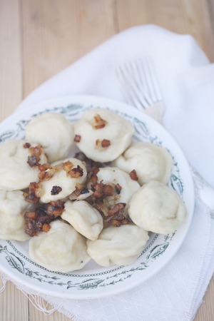 pelmeni with bacon on a wooden table, top viewの写真素材