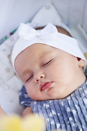 Little beautiful girl sleeping on a walkの写真素材